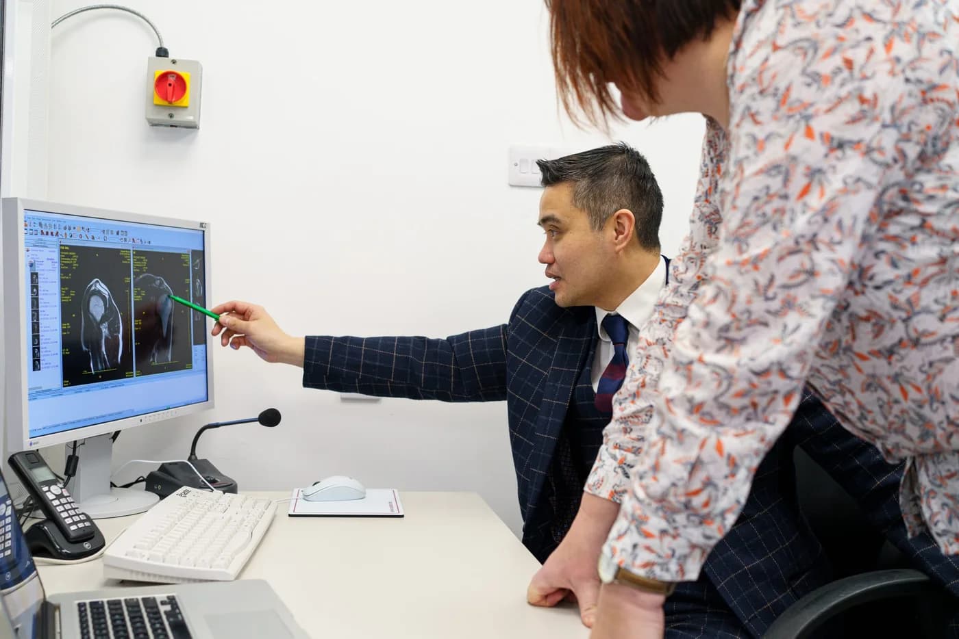 Professor Paul Lee explaining a scan in a consultation
